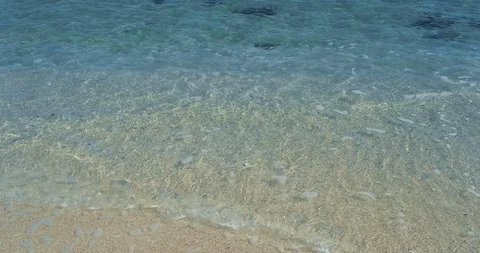Beautiful background transparent surface wave, sand on a clean beach Stock Footage 116085058