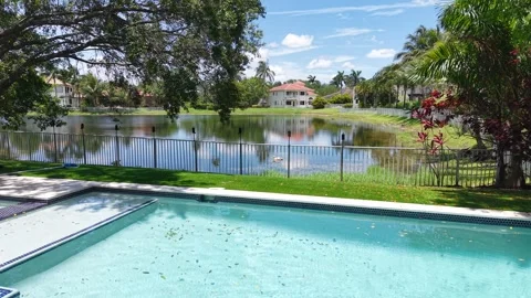 Beautiful Backyard Pool and Garden with Lush Greenery in Palmetto Bay, Florida Stock Footage 311340189