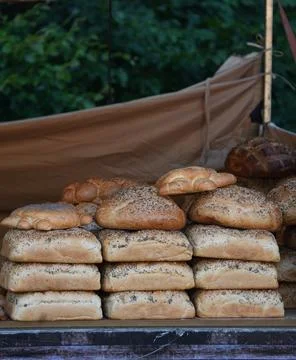 Beautiful baked bread in assortment folded for the showcase. Stock Photos