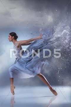The beautiful ballerina dancing in blue long dress Stock Photos