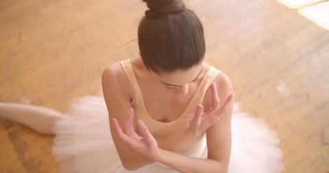 Beautiful ballerina performing ballet techniques in side split position Video stock 80274289