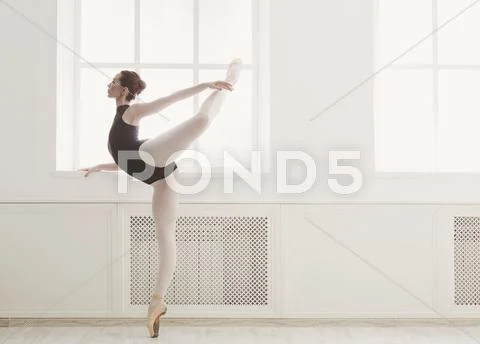 Beautiful ballerine stands in arabesque ballet position Stock Photos