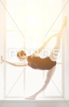 Beautiful ballerine stands in fifth ballet position Stock Photos