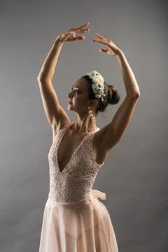 Beautiful ballet dancer posing on pointes on light grey studio background Stock Photos