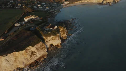 A beautiful beach with a cliff in the background Stock Footage 298252886