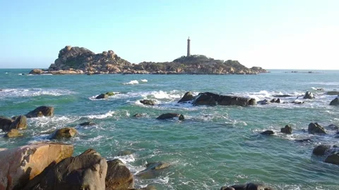 Beautiful beach in the lighthouse bay with waves crashing on the shore Stock Footage 145380896