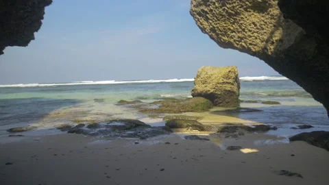 Beautiful beach lined with rocks and caves in Bali, Indonesia Stock Footage 223336473