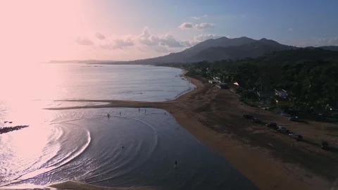 A beautiful beach with a mountain in the background Stock Footage 328387453
