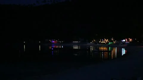 Beautiful Beach, night shot with the lights from resorts and restaurants. Stock Footage