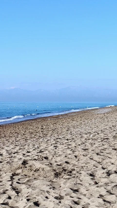Beautiful beach scenery with calm waves and soft sandy beach. Stock Footage 287482931