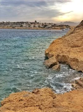 Beautiful beach with sheer cliffs, red sea Stock Photos