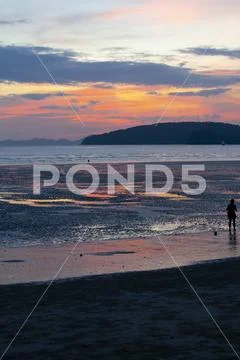 Beautiful beach sunset, blue and orange tones, reflections in water pools, Krab Stock Photos