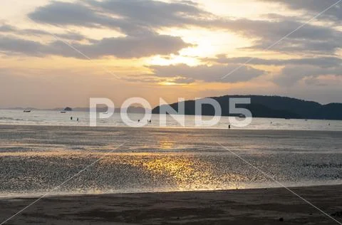 Beautiful beach sunset, no people, reflections in water pools Stock Photos
