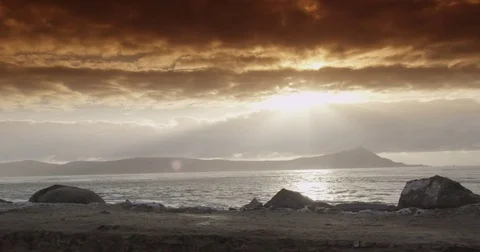 A beautiful beach sunset punctuated by an orange gradient filter Stock Footage 73011725