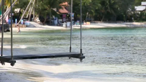 Beautiful beach with swing tied up to the tree on the sea shore. Stock Footage 12566424