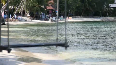 Beautiful beach with swing tied up to the tree on the sea shore. Stock Footage 12566575