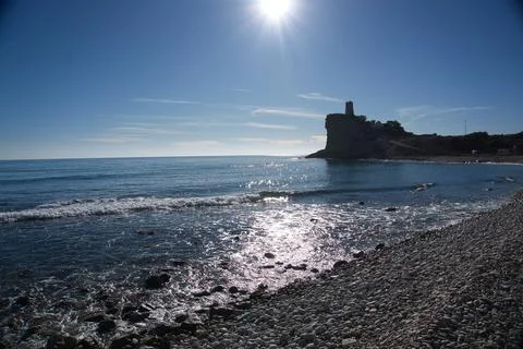Beautiful beach with a tower in the background, located in Alicante, Spain Stock Photos