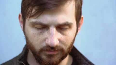 Beautiful bearded guy put on, take off face disposable mask on sunny day outdoor Stock Footage 129979111
