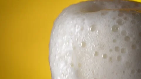 Beautiful beer foam flows down the edge of the glass. Light beer. Stock Footage 196887403