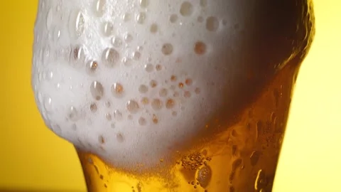 Beautiful beer foam flows down the glass. Light beer. Variant 1 Stock Footage 196887423