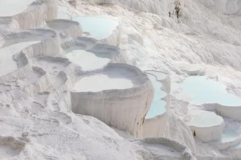 Beautiful bends in form of cloud of terraces with blue water on white mountain Stock Photos
