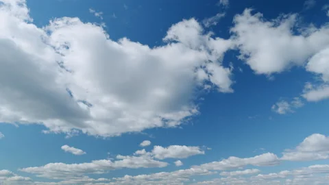 Beautiful big and fluffy clouds motion at sunny day in blue sky. White clouds Stock Footage 217691341