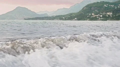 Beautiful big waves on the beach in the middle of the mountains Stock Footage 194136753