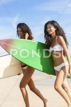 Beautiful bikini women surfers & surfboards at beach Stock Photos