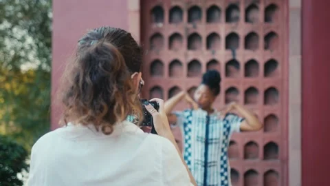 A beautiful black model poses for a photographer. Stylish fashion photo shoot in 動画素材 170242545