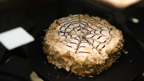 Beautiful black white hazelnut esterhazy cake topped almond slices on black plat Vídeos de archivo 299849379