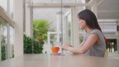 Beautiful blogger using smartphone at table in cafe Stock Footage 79660039