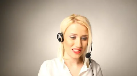 Beautiful blond help desk operator smiling and talking Stock Footage 10583990