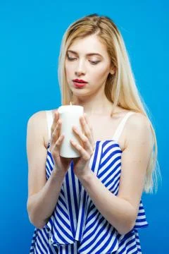Beautiful Blonde with Bare Shoulders Wearing Striped Dress is Holding White Photos