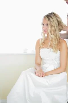 Beautiful blonde bride being prepared for the wedding Stock Photos