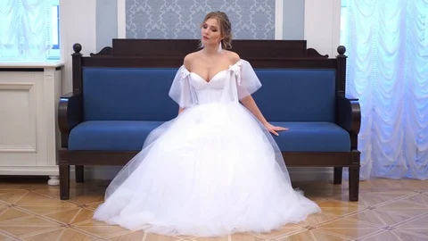 Beautiful blonde bride poses in a chic rich indoor Stock Footage 102385149