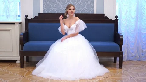 Beautiful blonde bride poses in a chic rich indoor Stock Footage 102441996