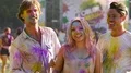 Beautiful blonde female throwing handful of color powder in air, enjoying life HD Footage
