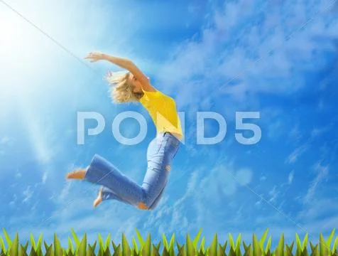 Beautiful blonde girl jumps over green grass Stock Photos
