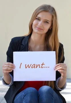 Beautiful blonde with the inscription on the white paper "I want..." Stock Photos