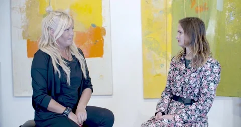 Beautiful blonde lady an interview in the studio Video stock 148935484