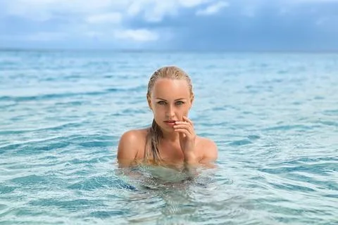 Beautiful blonde mermaid emerged from the water. Stock Photos