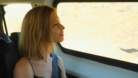 Beautiful Blonde Model Looking Outside the Window of a Moving Van Stock Footage 114324056