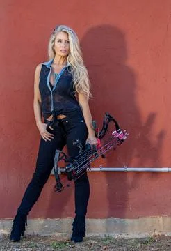Beautiful Blonde Model Posing With A Bow And Arrow Outdoors Stock Photos