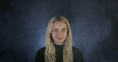Beautiful Blonde Model Smiling As Smoke Rises behind in Slo-mo. Stock Footage 109206191