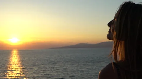 Beautiful blonde model staring into sunset silhouette mykonos greece slow motion Stock Footage 67855183
