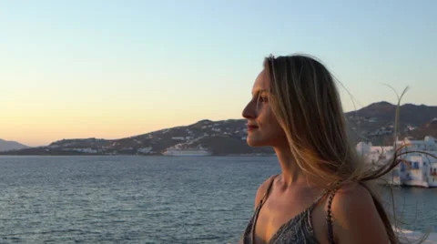 Beautiful blonde model staring into sunset mykonos greece slow motion Stock Footage 67859391