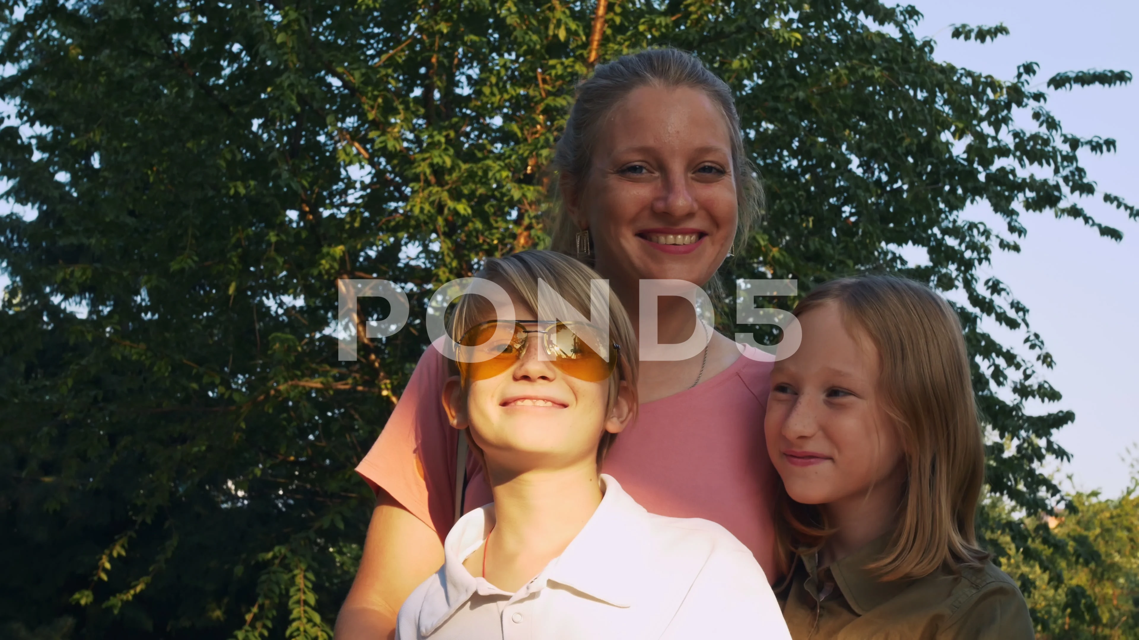 Beautiful blonde mom with two children h... | Stock Video | Pond5