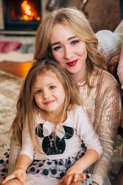 Beautiful blonde posing for the camera with a child Stock Photos