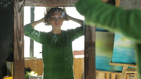 The beautiful blonde posing in front of a mirror and brushing her hair Stock Footage 61848984