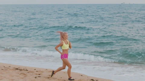 Beautiful blonde practicing at the beach. 4k cinematic video Stock Footage 91594263